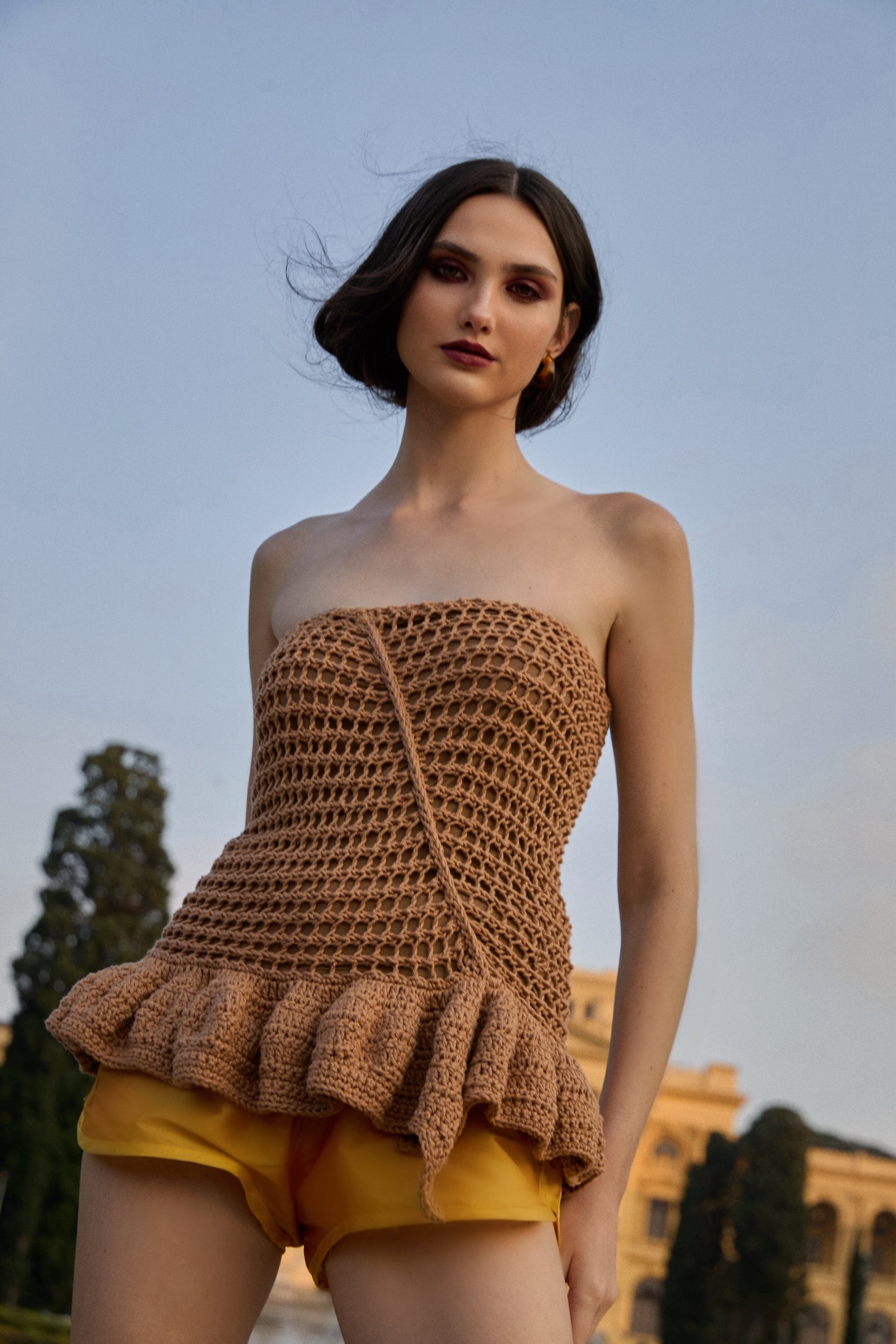 Blusa sem alças com decote reto, da marca Isabela Monteiro, feita à mão em tricô e em crochê. 100% algodao. Forro fresquinho em malha de poliamida. Para completar o look, shorts em tafetá amarelo, também da marca Isabela Monteiro.